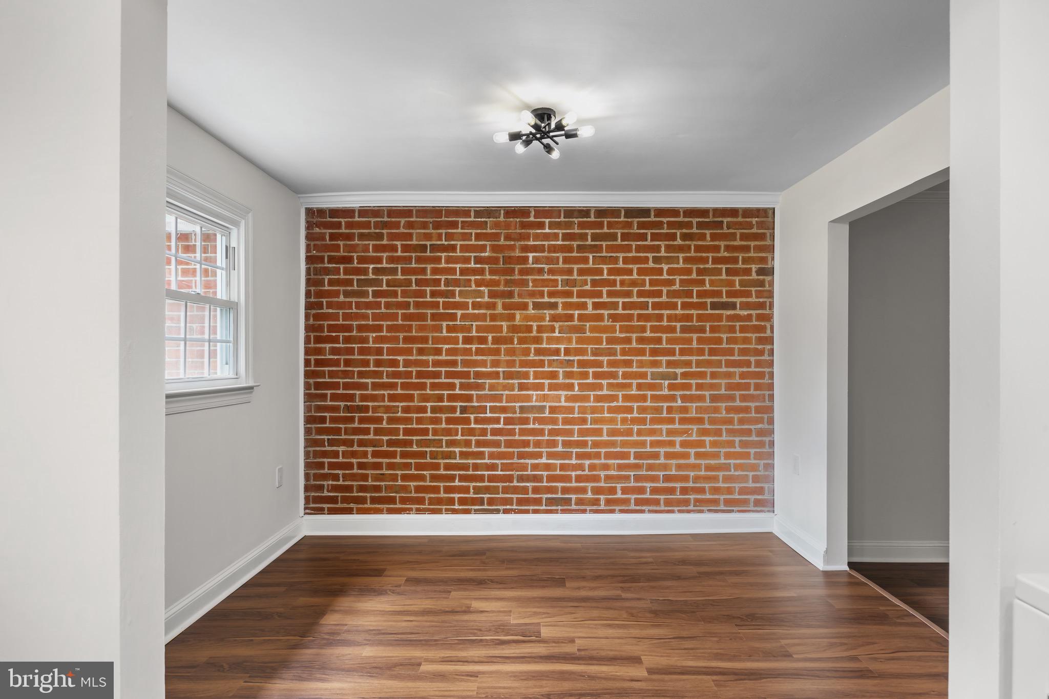 207 Yardley Commons Yardley, PA 19067 - Photo 8 of 19 a view of an empty room with wooden floor and a window