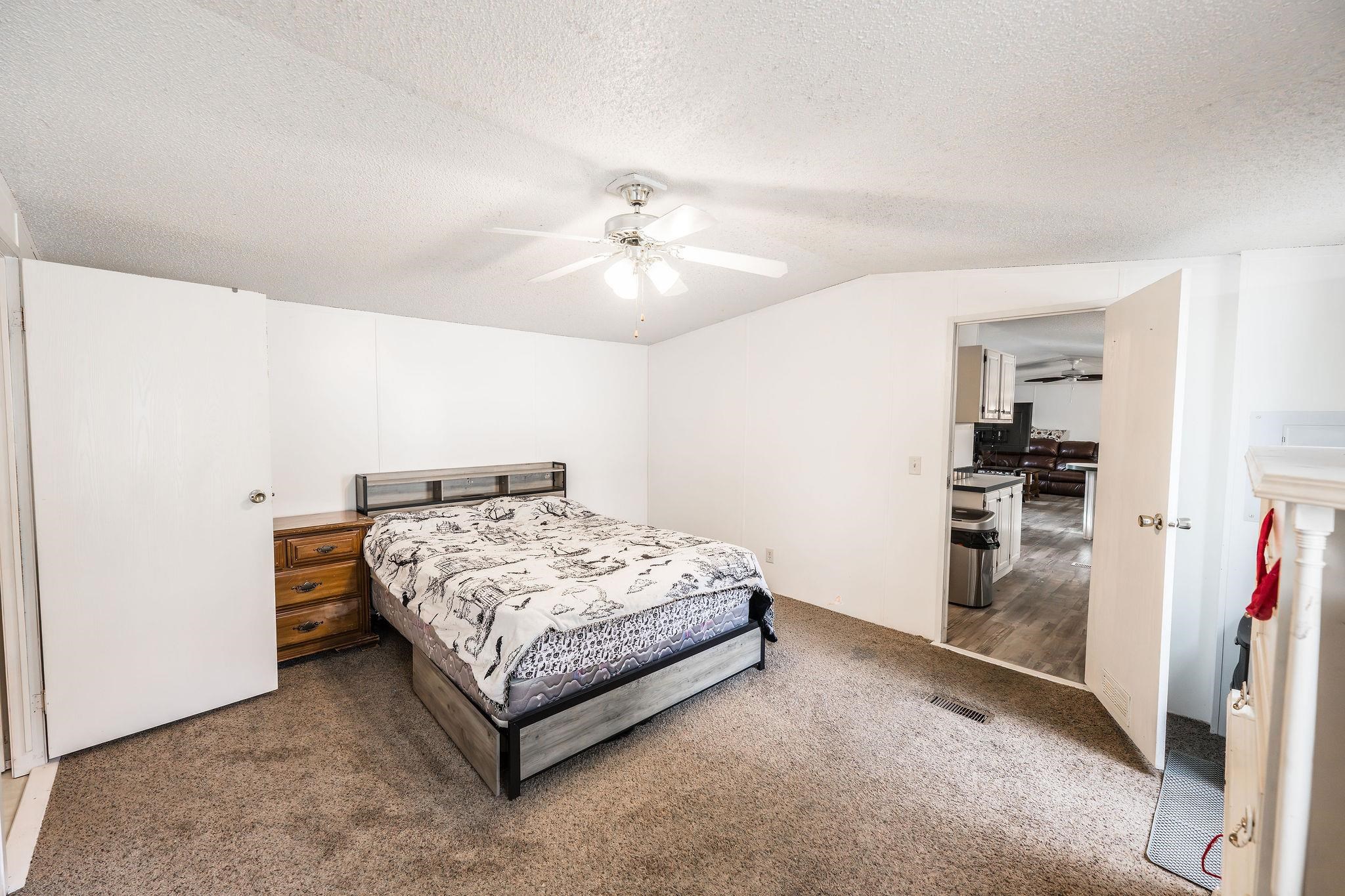 435 32 Road, Unit 620 Clifton, CO 81520 - Photo 11 of 20 a bedroom with a bed and a chandelier