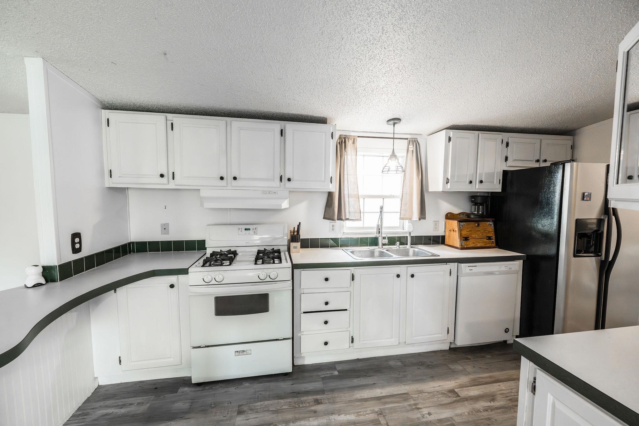 435 32 Road, Unit 620 Clifton, CO 81520 - Photo 6 of 20 a kitchen with granite countertop white cabinets and white appliances