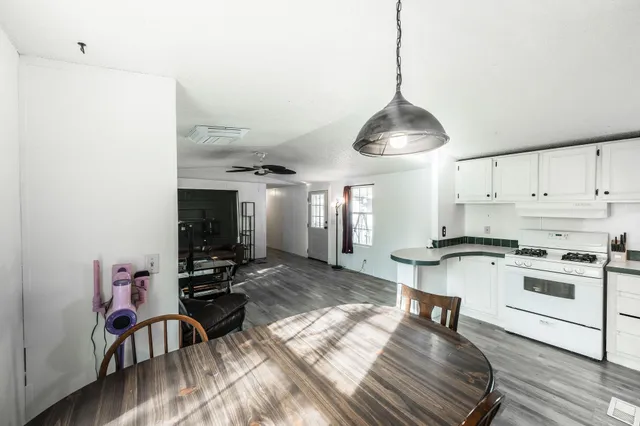 a kitchen with stove and white cabinets