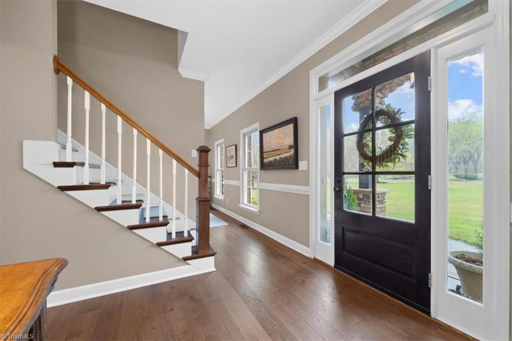 5515 Union Grove Road Oak Ridge, NC 27310 - Photo 5 of 37 Step into the foyer with engineered hardwood floors on main level.