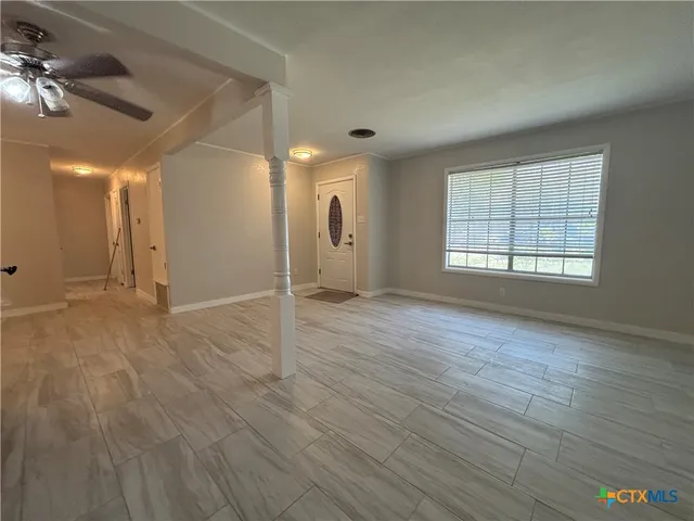 wooden floor in an empty room with a window