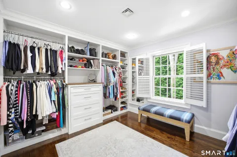 a view of a bedroom with clothes and shoes