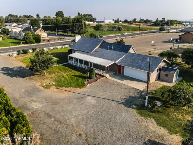 an aerial view of a house with outdoor space
