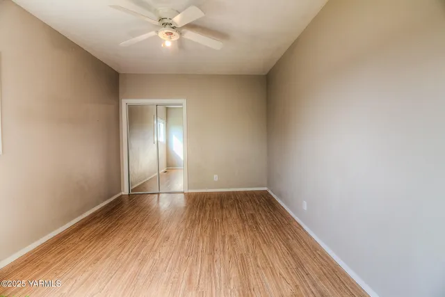 wooden floor in an empty room with a window