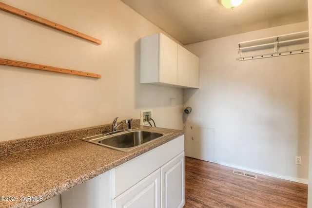 a kitchen with a sink and cabinets