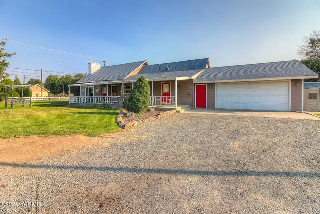 a front view of house with yard and lake view