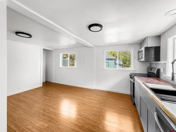a view of a kitchen with a sink and a window