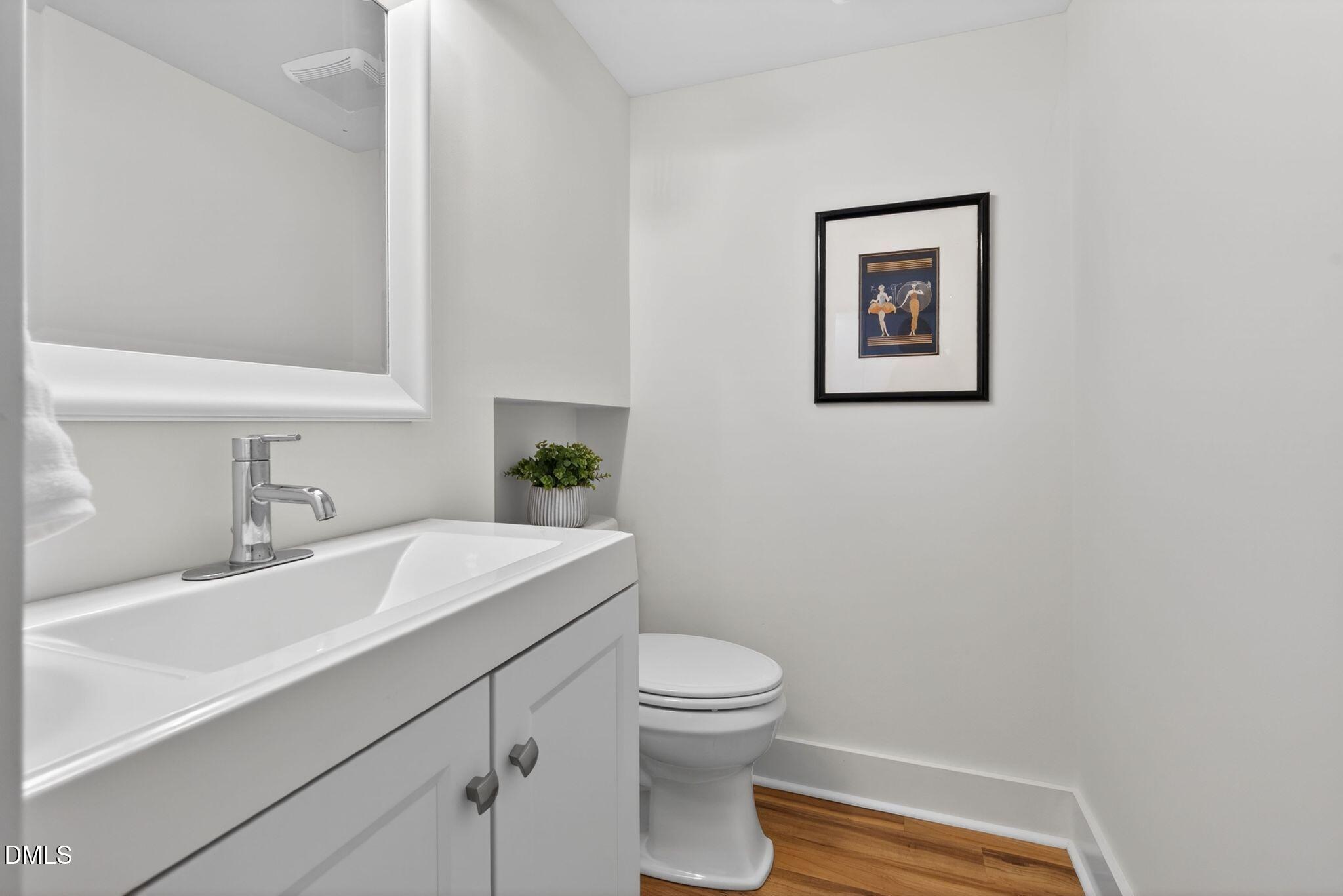 7149 Sandy Creek Drive Raleigh, NC 27615 - Photo 12 of 23 a bathroom with a sink mirror vanity and toilet