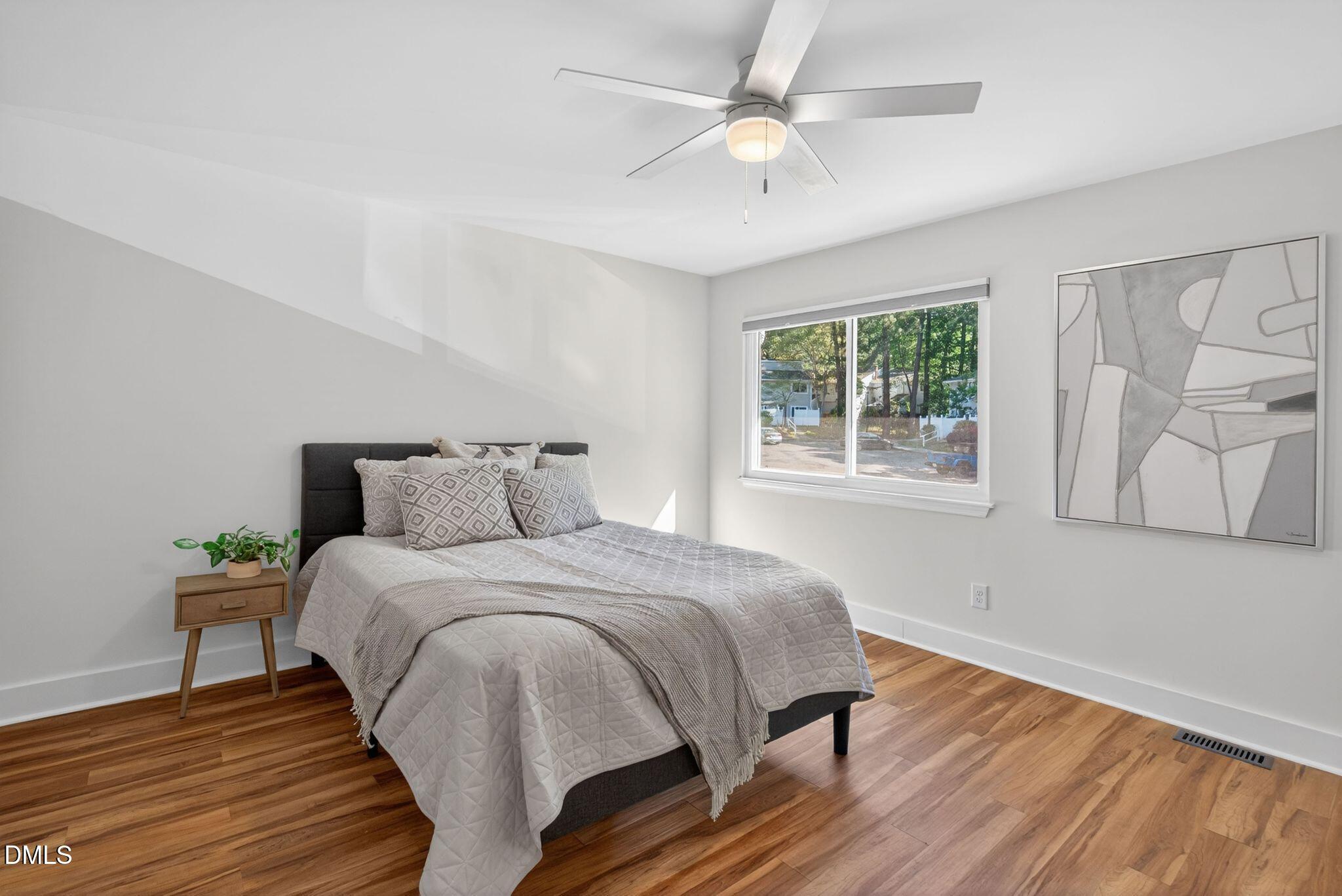7149 Sandy Creek Drive Raleigh, NC 27615 - Photo 14 of 23 a bedroom with a bed and a window