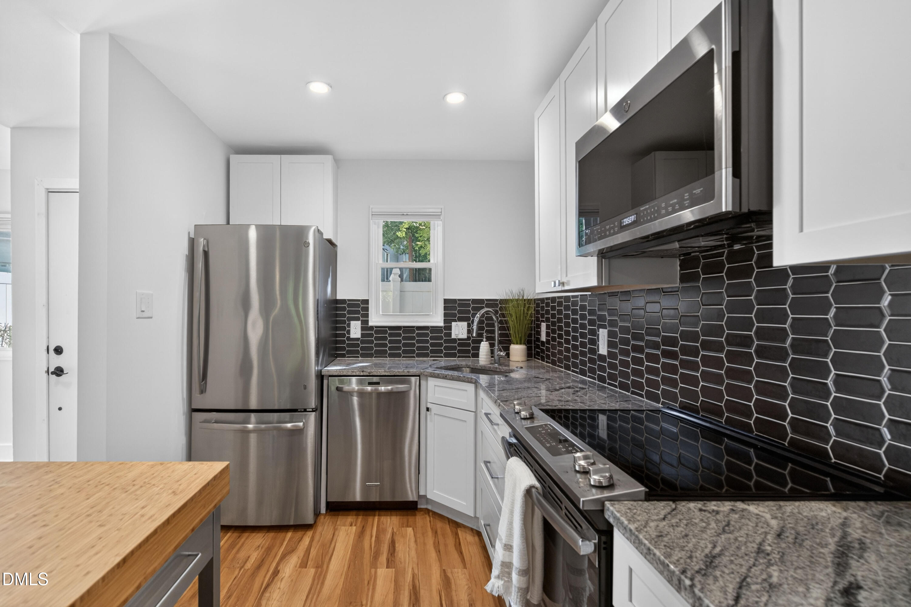 7149 Sandy Creek Drive Raleigh, NC 27615 - Photo 4 of 23 a kitchen with a sink stove and refrigerator