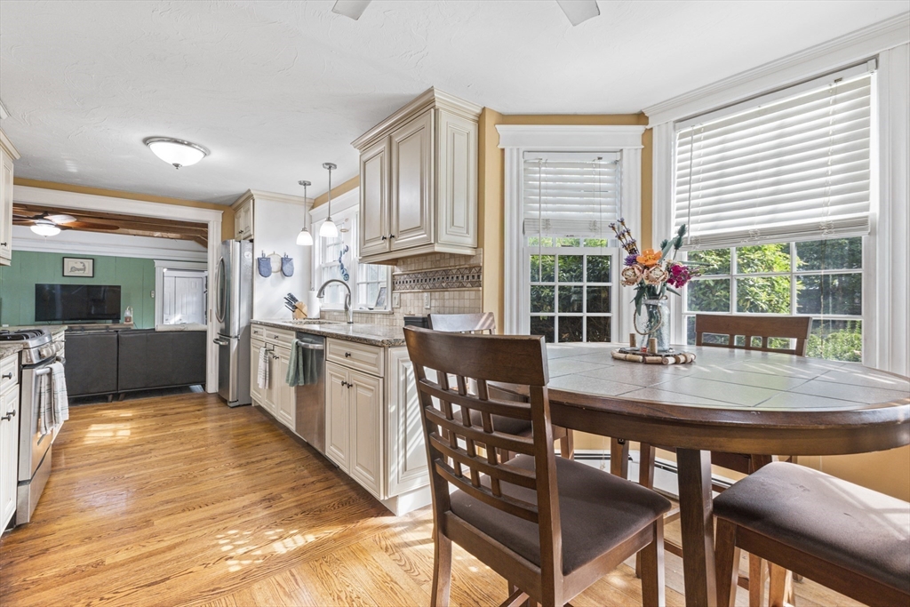 380 North Main Street Sharon, MA 02067 - Photo 11 of 35 a kitchen with stainless steel appliances granite countertop a stove a sink a refrigerator dining table and chairs