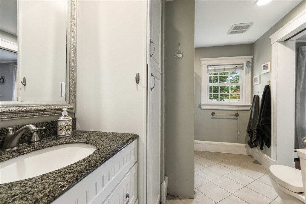 380 North Main Street Sharon, MA 02067 - Photo 19 of 35 a bathroom with a granite countertop sink and a mirror