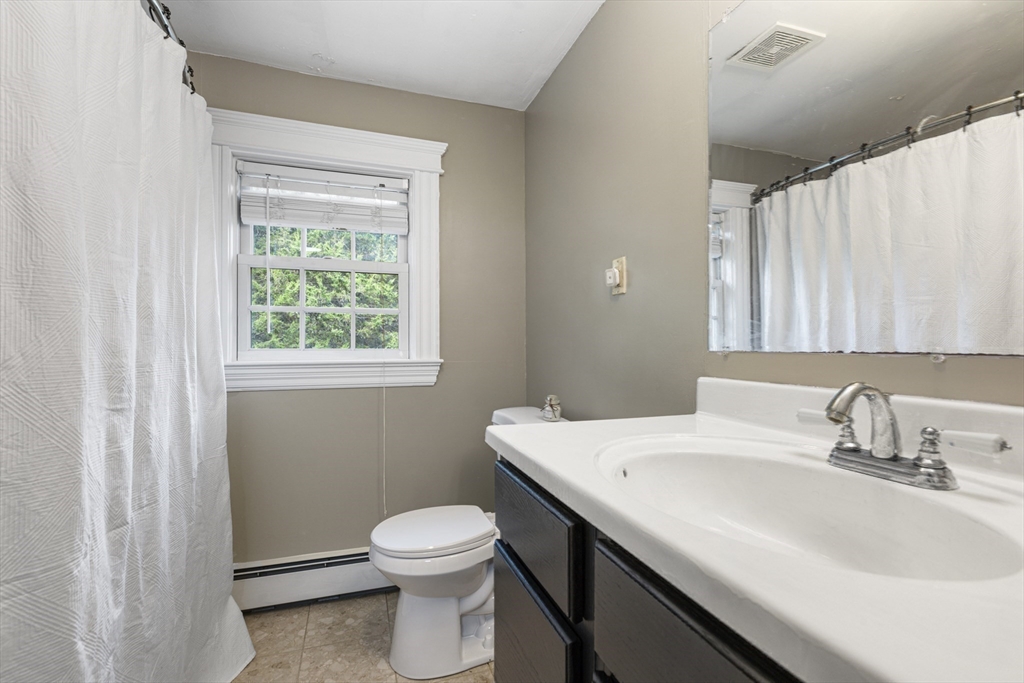 380 North Main Street Sharon, MA 02067 - Photo 27 of 35 a bathroom with a sink a toilet and a window