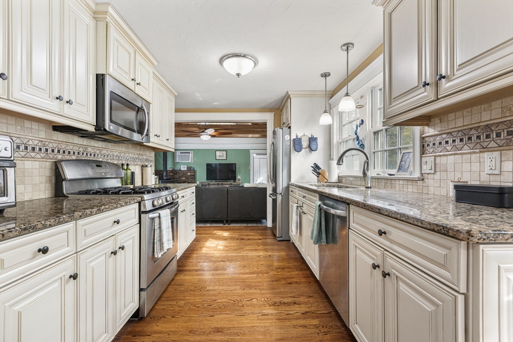 380 North Main Street Sharon, MA 02067 - Photo 8 of 35 a kitchen with stainless steel appliances granite countertop a sink and dishwasher a stove top oven with wooden floor
