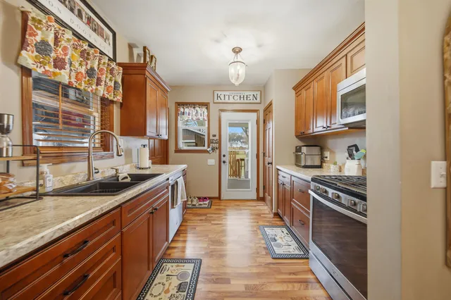 a kitchen with stainless steel appliances granite countertop a stove and a sink