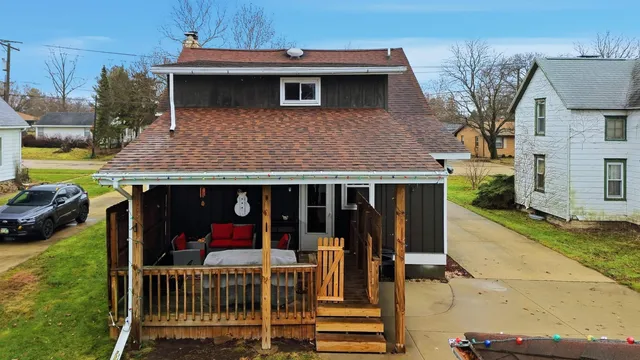 a front view of a house with a yard table and chairs