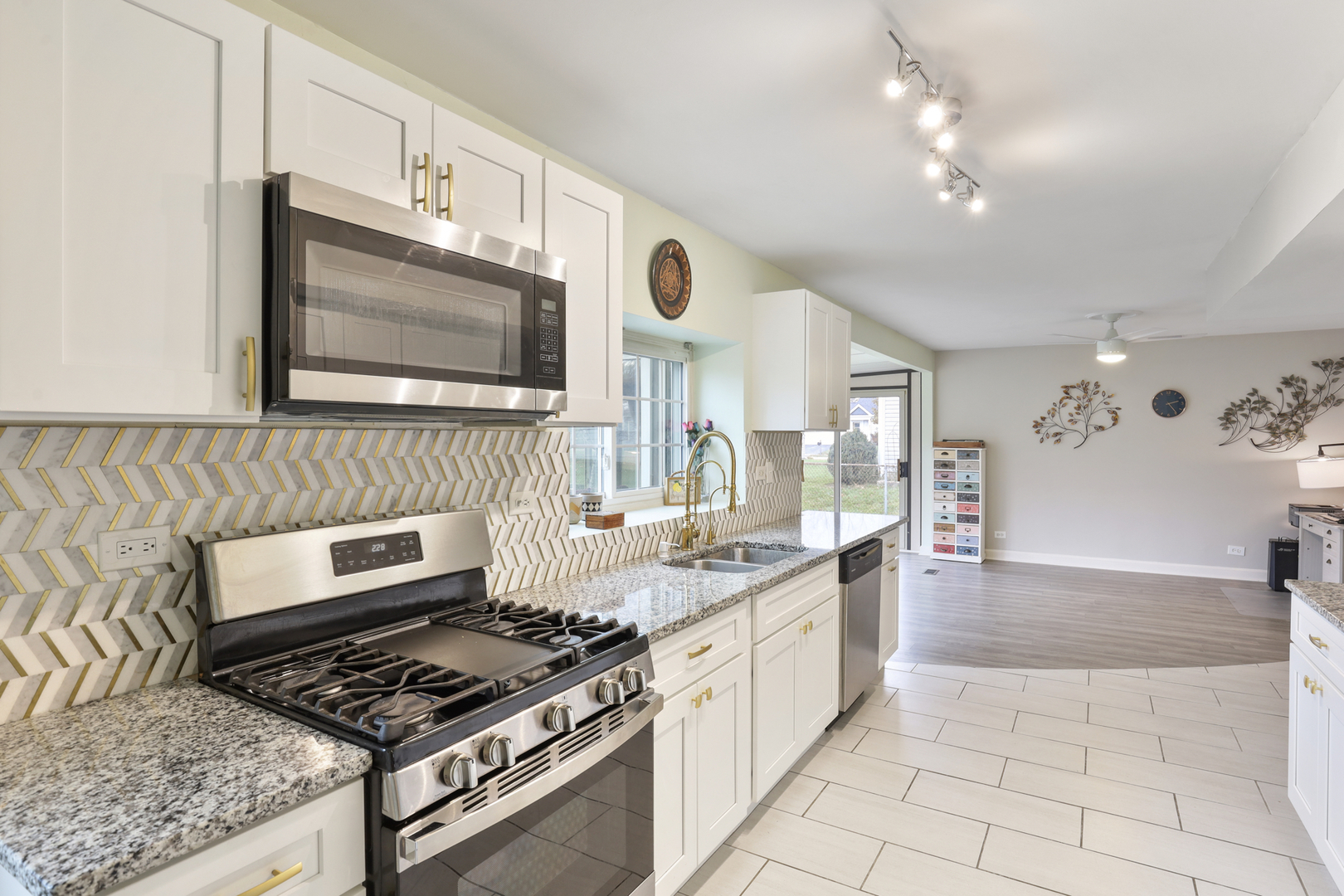 1475 Farrington Lane Aurora, IL 60504 - Photo 23 of 45 a kitchen with stainless steel appliances granite countertop a stove a sink and a microwave