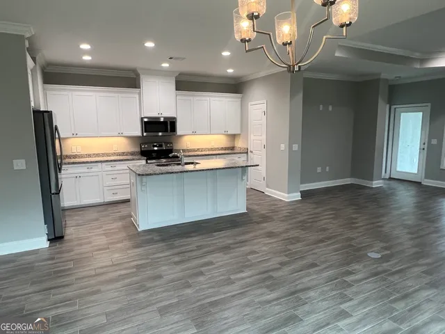 a view of kitchen and kitchen with a sink