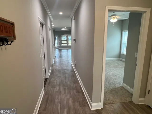 a view of hallway with wooden floor