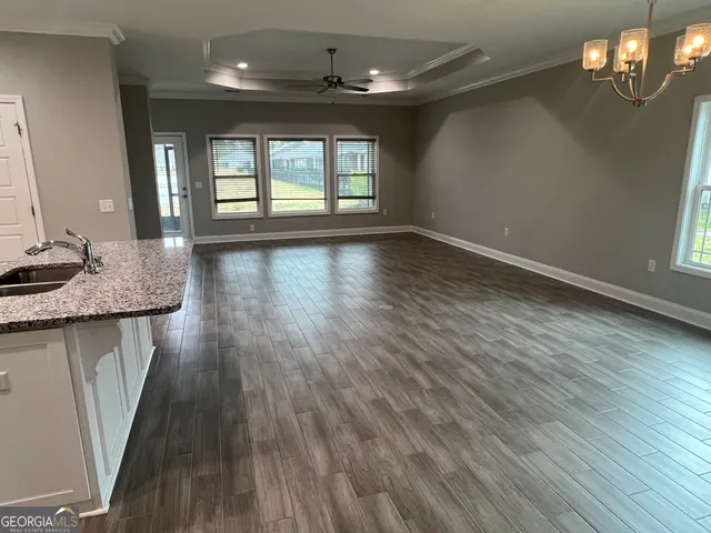 a kitchen with kitchen island stainless steel appliances a sink and a refrigerator