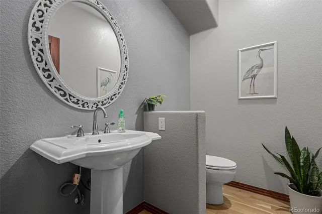 a bathroom with a toilet a sink and a mirror