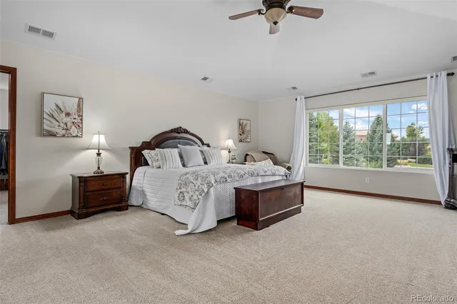 a bedroom with a bed a couch and a window