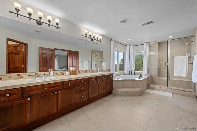 a large bathroom with a large mirror vanity shower and view