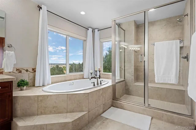 a spacious bathroom with a tub shower and sink