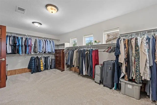 a walk in closet with a mirror