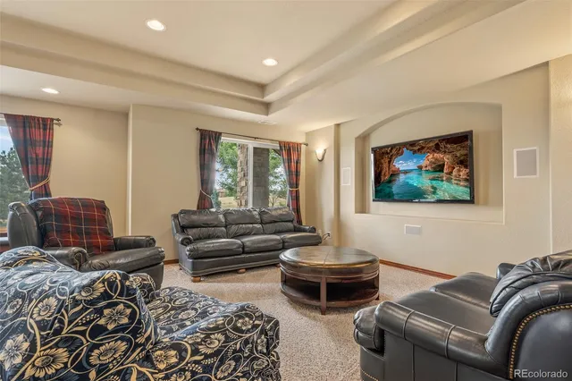 a living room with furniture a couch and two windows