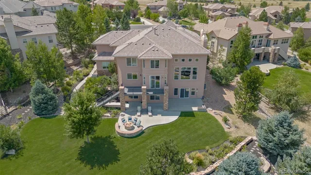 an aerial view of a house with garden space and street view