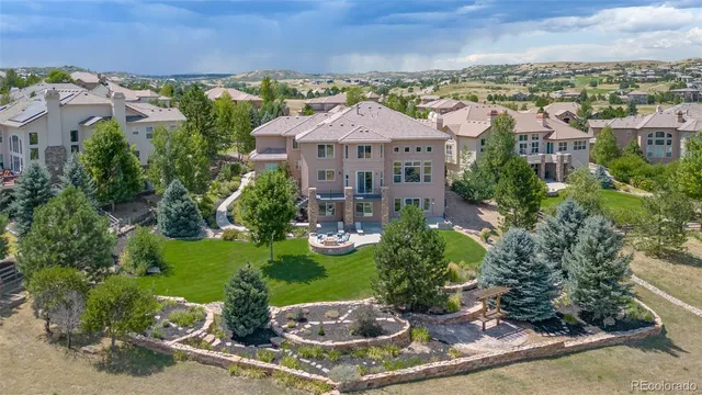 an aerial view of a house with a garden and lake view