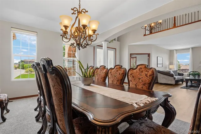 a view of a dining room with furniture and chandelier