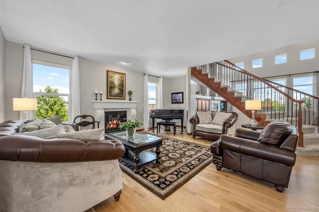 a living room with furniture a fireplace and a window