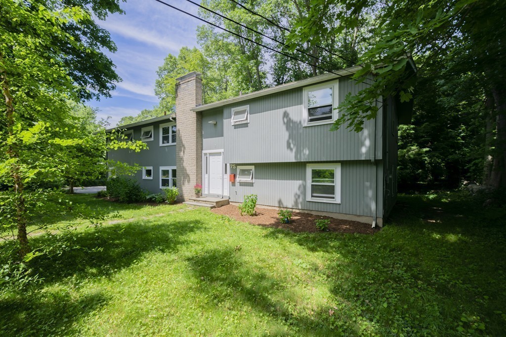 75 Reed Street Lexington, MA 02421 - Photo 1 of 30 a backyard of a house with table and chairs plants and large tree
