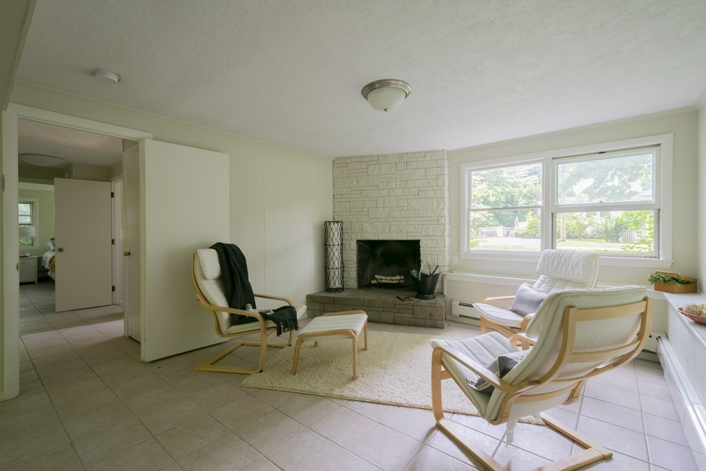 75 Reed Street Lexington, MA 02421 - Photo 27 of 30 a living room with furniture a fireplace and a flat screen tv
