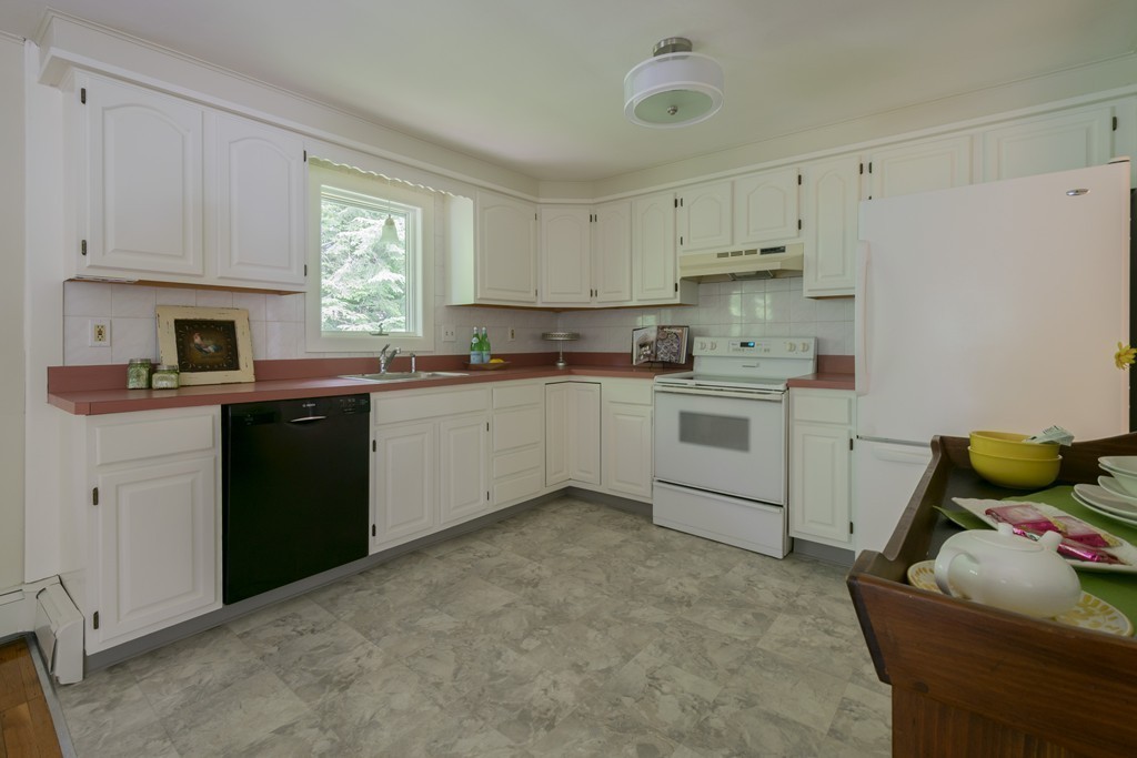 75 Reed Street Lexington, MA 02421 - Photo 10 of 30 a kitchen with a sink stove and cabinets