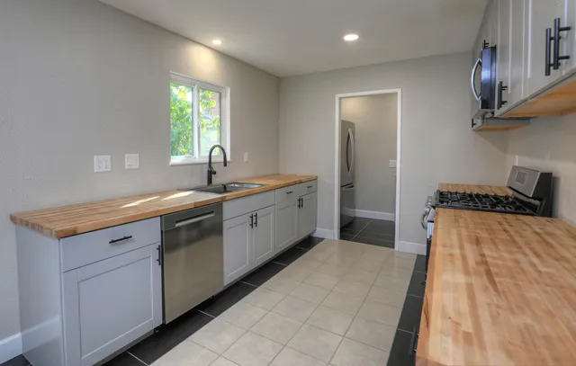 a spacious bathroom with a sink a mirror and window