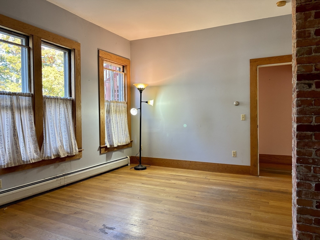 527 Main Street, Unit 1 Ashfield, MA 01330 - Photo 5 of 24 an empty room with wooden floor and a window