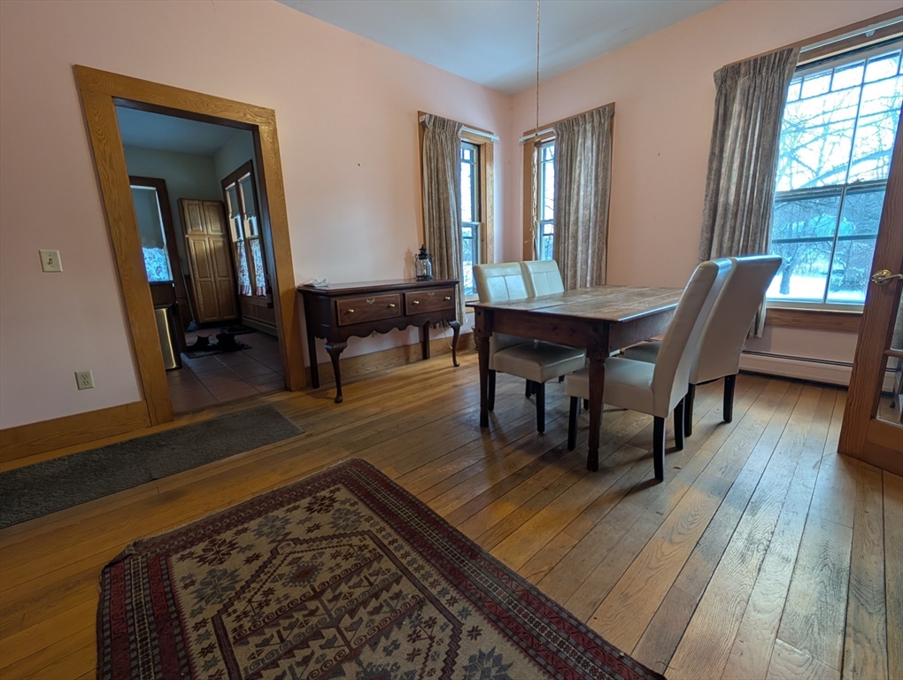 527 Main Street, Unit 1 Ashfield, MA 01330 - Photo 8 of 24 a view of a dining room with furniture and wooden floor
