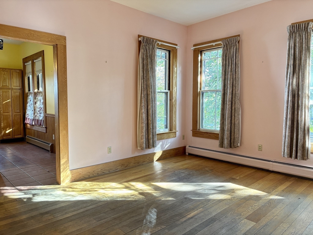 527 Main Street, Unit 1 Ashfield, MA 01330 - Photo 10 of 24 a view of an empty room with window and wooden floor