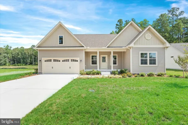 a view of a yard in front of a house with plants