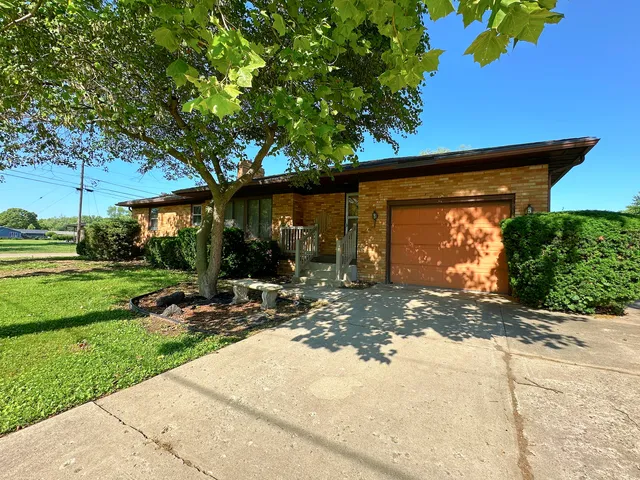 a front view of a house with garden and patio