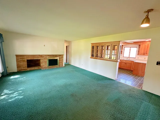 a view of living room with furniture and fireplace