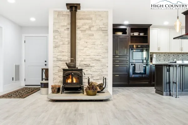 a kitchen with kitchen island granite countertop a sink appliances and cabinets