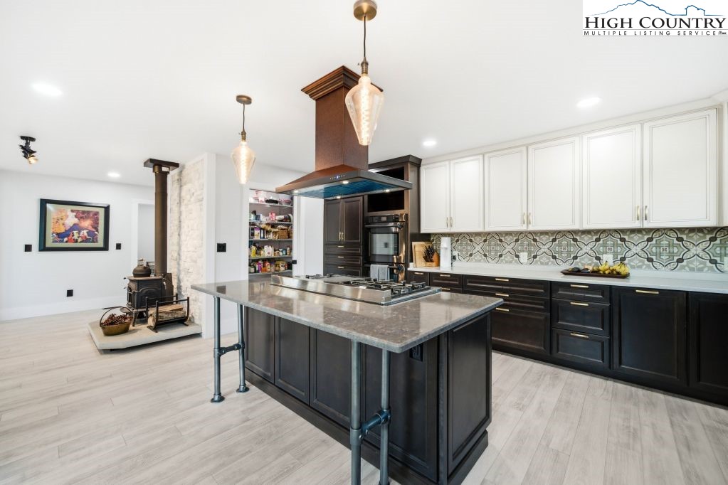 370 Laws Road Limestone, TN 37681 - Photo 25 of 49 a kitchen with kitchen island granite countertop a sink appliances and cabinets