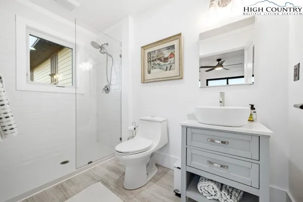 a bathroom with a glass shower door