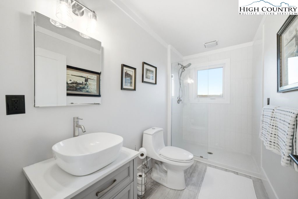370 Laws Road Limestone, TN 37681 - Photo 39 of 49 a white toilet sitting next to a bathroom sink