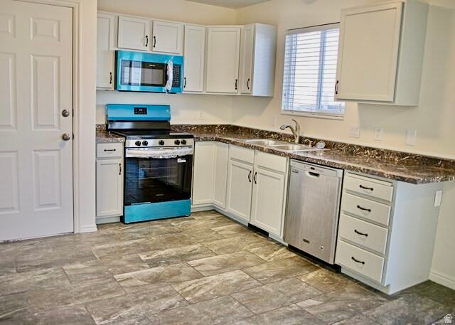 778 North 250 West Springville, UT 84663 - Photo 3 of 16 Kitchen featuring dark countertops, stainless steel appliances, and white cabinetry